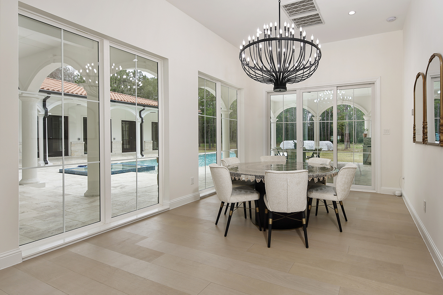 Breakfast room framed by arched courtyard views