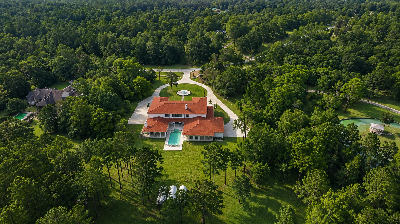 Rear aerial view showing pool and grounds